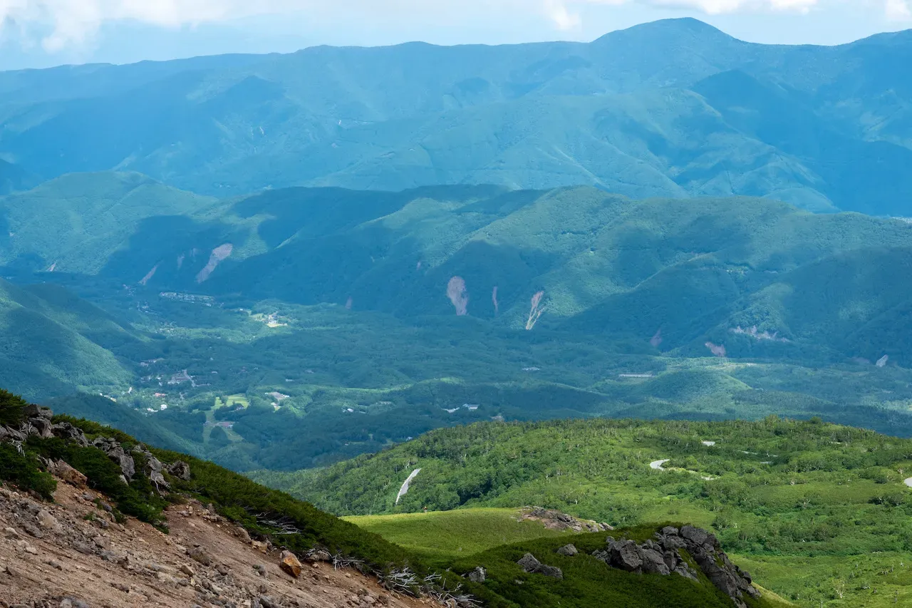 山頂から望む幾重にも重なる緑の山並み